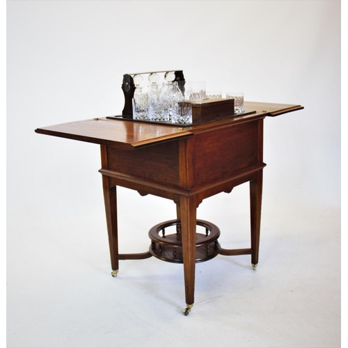 841 - An early 20th century metamorphic oak drinks table/ cabinet by Finnigans Ltd, Manchester, with a ris... 