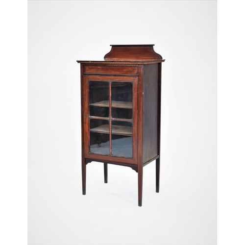 842 - An Edwardian music cabinet, with a single glazed door, raised upon legs of tapering square section, ... 