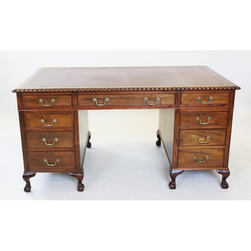 847 - A George II style mahogany desk, 20th century, having a gilt tooled leather writing surface within a... 