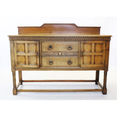 857 - An early 20th century golden oak Jacobean revival sideboard, with a dwarf back above a rectangular m... 