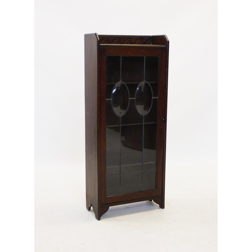 858 - An Arts and Crafts glazed oak bookcase,with a galleried top above a leaded and stained glass door, e... 