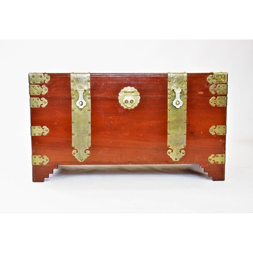 862 - A 20th century Oriental camphor wood trunk, of rectangular form, with ornate brass fittings, decorat... 