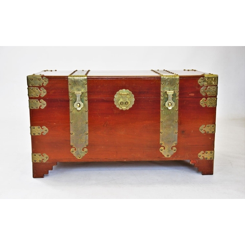 862 - A 20th century Oriental camphor wood trunk, of rectangular form, with ornate brass fittings, decorat... 