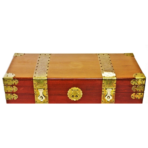 862 - A 20th century Oriental camphor wood trunk, of rectangular form, with ornate brass fittings, decorat... 