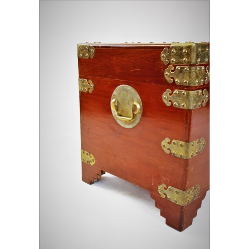 862 - A 20th century Oriental camphor wood trunk, of rectangular form, with ornate brass fittings, decorat... 