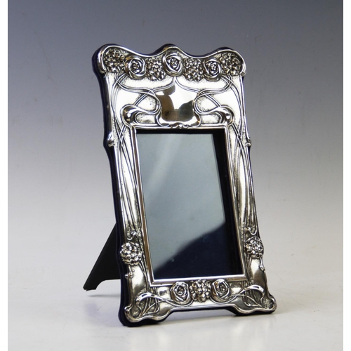 88 - An Edwardian Art Nouveau silver frame, Horton & Allday, Birmingham 1904, of rectangular form, design... 