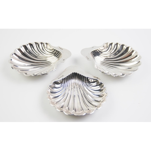 91 - A pair of Victorian silver butter dishes in the form of scallop shells on three ball feet by Sibray,... 