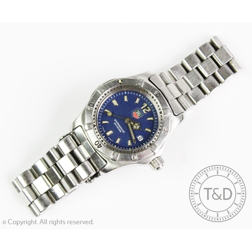 118 - A Tag Heuer stainless steel wristwatch, the navy blue circular dial with luminous baton markers and ... 