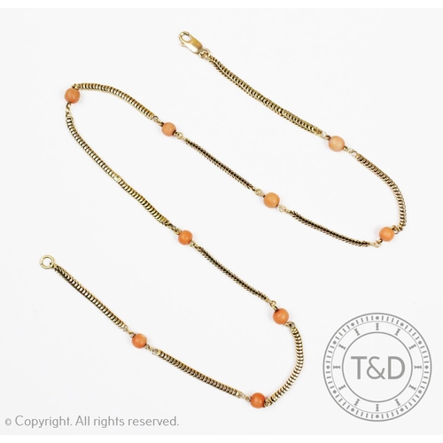 124 - A coral link necklace, the snake link yellow metal chain interspersed with nine coral bead spacers, ... 