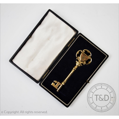 31 - LOCAL INTEREST: A silver gilt presentation key, Vaughton & Sons, Birmingham 1920, with scroll form d... 