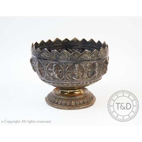 59 - A Burmese silver bowl, the white metal bowl with a continuous band of dancing figures within roundel... 