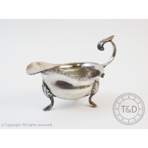 60 - A George V silver sauce boat, William Neale, Birmingham 1921, of typical plain polished form, with  ... 