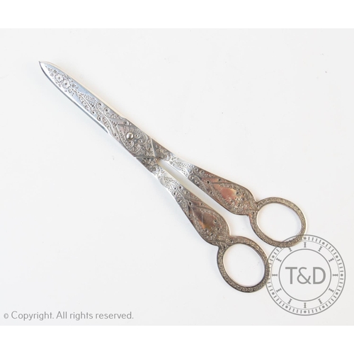 64 - A pair of Victorian silver grape scissors, John Aldwinckle & Thomas Slater, London 1890, of typical ... 