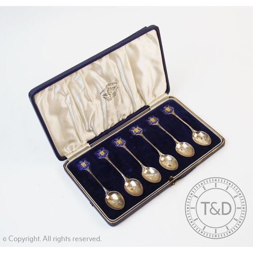 74 - A set of early 20th century six white metal and enamel teaspoons, each with blue and yellow enamelle... 