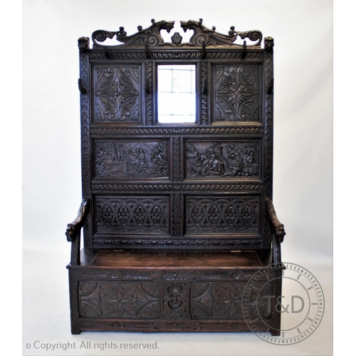 813 - A 19th century carved oak high back settle, circa 1870, with a twin dragon mask pediment above a pan... 