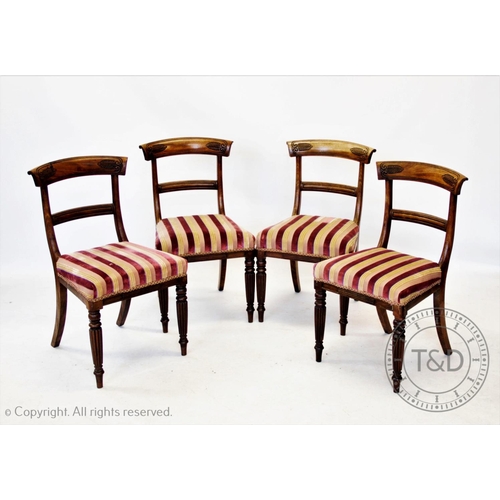 824 - A set of four Regency mahogany dining chairs, the rail backs incised with stylised leaves above an o... 