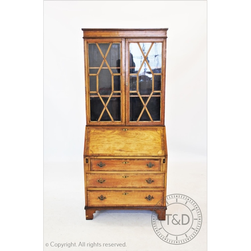 828 - A 19th century satin walnut bureau bookcase, with a cross banded frieze above a pair of astragal gla... 