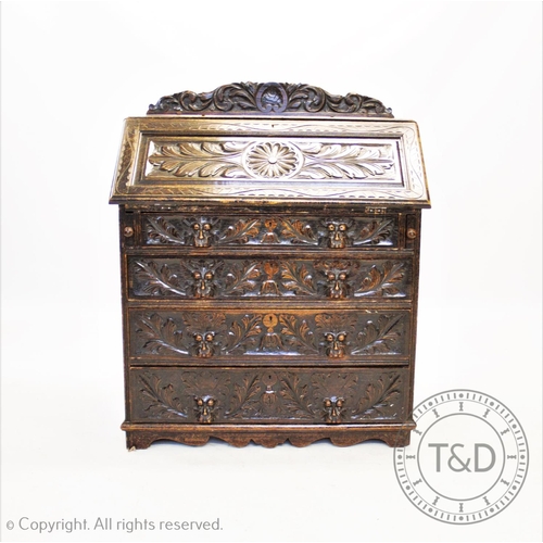 837 - A Victorian carved oak Green Man bureau, with a carved raised back above a profusely carved fall fro... 