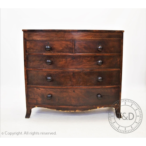 843 - An early 19th century bow front mahogany chest of drawers, with an arrangement of two short and thre... 