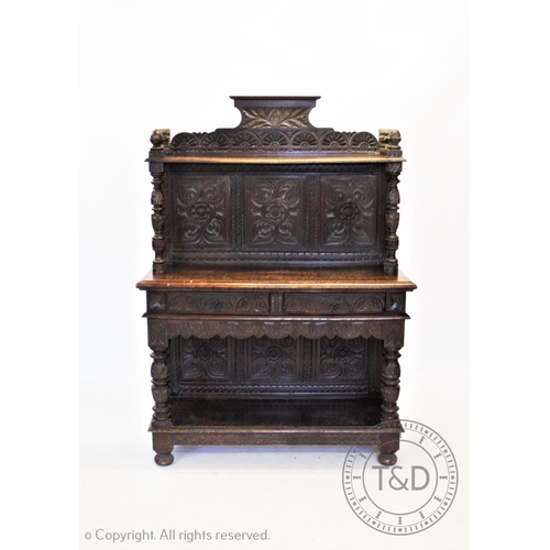 845 - A Victorian carved oak buffet/sideboard, the three panel back carved with flower heads below a shelf... 