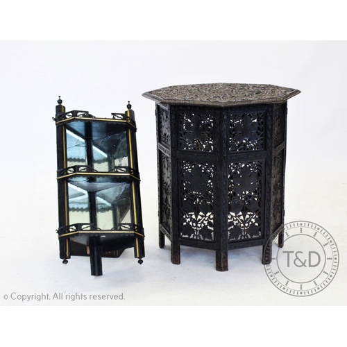 853 - An early 20th century Anglo Indian carved hardwood  table, the ebonised octagonal top carved in reli... 