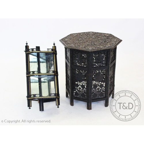 853 - An early 20th century Anglo Indian carved hardwood  table, the ebonised octagonal top carved in reli... 