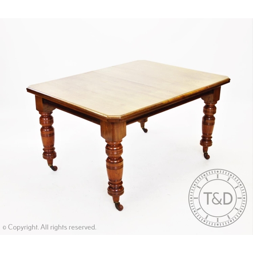 862 - An Edwardian walnut extending dining table, with one extra leaf, the rectangular moulded top with ca... 