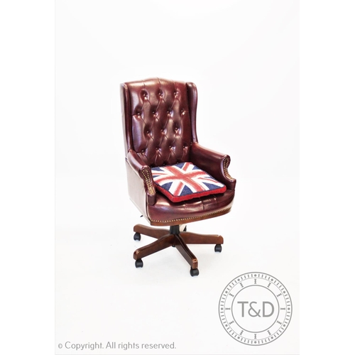 864 - A mauve leather high back office chair, 20th century, the button back with dwarf wing backs above a ... 