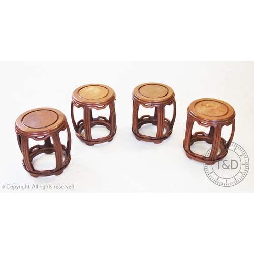 868 - Four Japanese influence hardwood urn stands, of barrel form, the circular top raised upon five reede... 