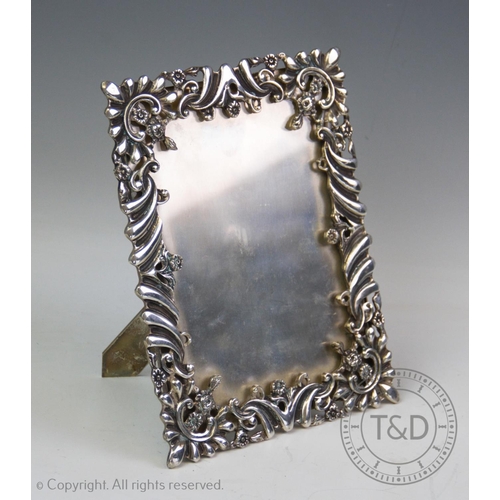 88 - An early 20th century white metal frame, of rectangular form, designed with a pierced foliate and sc... 