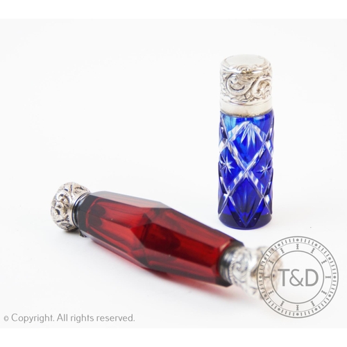 91 - A Victorian white metal mounted double-ended scent bottle, with red cut glass body, of faceted cylin... 