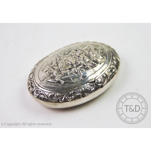 1 - A 19th century Dutch silver snuff box, of oval form, the cover decorated with embossed figures on a ... 