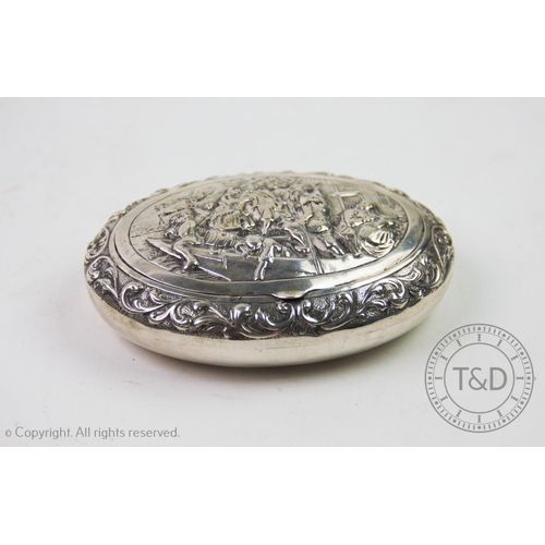 1 - A 19th century Dutch silver snuff box, of oval form, the cover decorated with embossed figures on a ... 