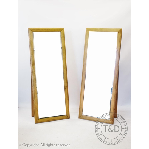 873 - Two contemporary light oak cheval mirrors,the bevelled mirrored plate within a moulded frame with re... 