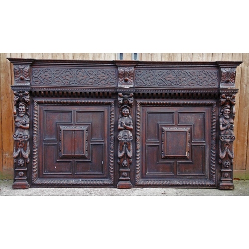 838 - A large Victorian carved oak panel, modelled with two multi fielded panels, divided by carved figure... 