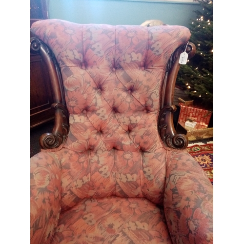 815 - A near pair of William IV mahogany framed armchairs, each chair with a padded button back flanked by... 