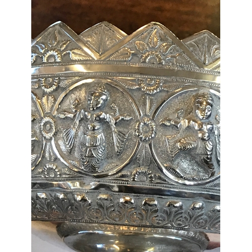 59 - A Burmese silver bowl, the white metal bowl with a continuous band of dancing figures within roundel... 