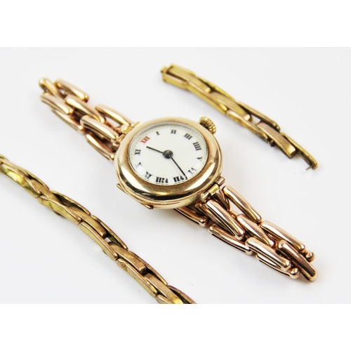 107 - A lady's 9ct gold wristwatch, London 1920-21, the circular white enamel dial with black Roman numera... 