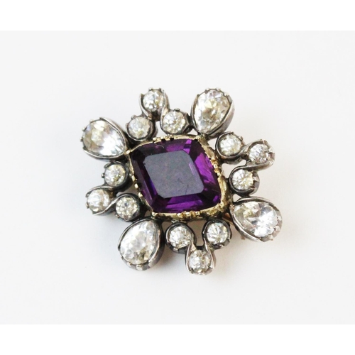 133 - A Victorian paste set cluster brooch, comprising a central step cut purple paste set in yellow metal... 