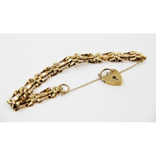 136 - A 9ct gold gatelink bracelet, London 1977, with attached 9ct gold padlock clasp and safety chain, 16... 