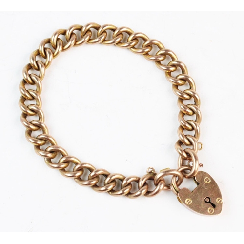 142 - A yellow metal curb link bracelet, each stamped '9CT' length 19cm, suspending a heart shaped padlock... 