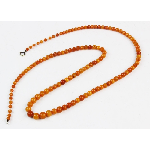 144 - A 'Butterscotch' amber bead necklace, comprising 125 graduating off-round beads, spring ring and sim... 