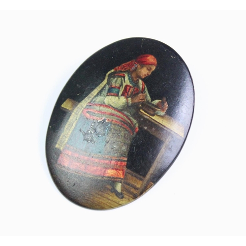 149A - A late 19th century Russian hand-painted papier-mache brooch by Lukutin, depicting a woman in tradit... 