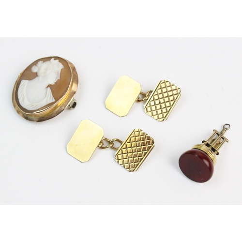 155 - A pair of 9ct gold cufflinks, the rectangular form cufflinks with truncated corners and engraved dec... 