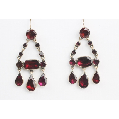 164 - A pair of Georgian garnet set drop earrings, each comprising pear-shaped, oval and round flat-cut ga... 