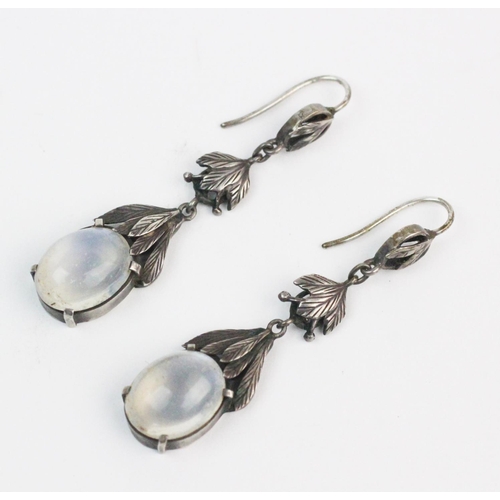 168 - A pair of Arts & Crafts style moonstone set drop earrings, each comprising an oval moonstone cabocho... 