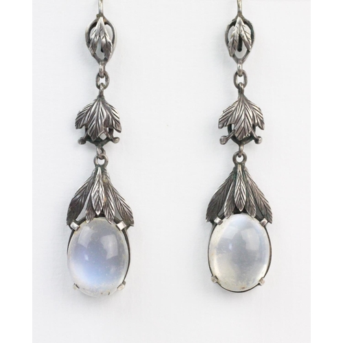 168 - A pair of Arts & Crafts style moonstone set drop earrings, each comprising an oval moonstone cabocho... 