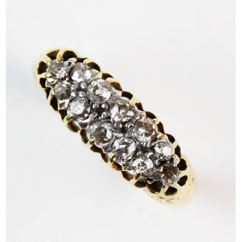 181 - A diamond set two-row ring, comprising 12 small mine cut diamonds, claw set to a yellow metal pierce... 