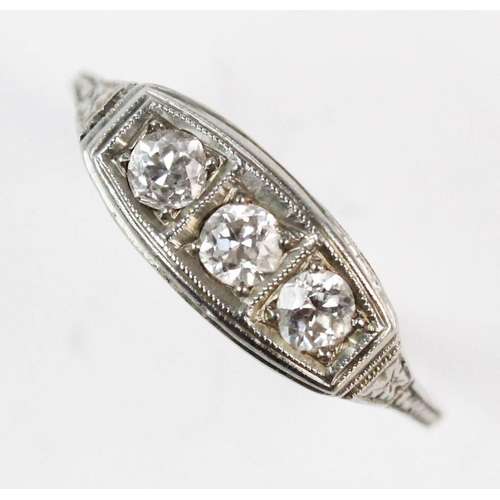 185 - A three-stone boat-shaped diamond ring, comprising three old cut diamonds, claw set to a white metal... 