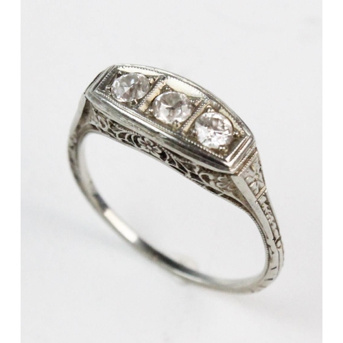 185 - A three-stone boat-shaped diamond ring, comprising three old cut diamonds, claw set to a white metal... 